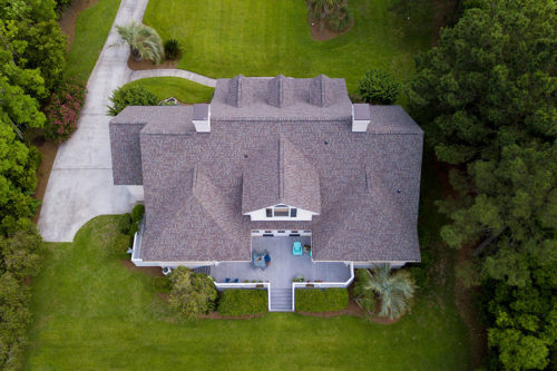 aerial view of house with gray roofing